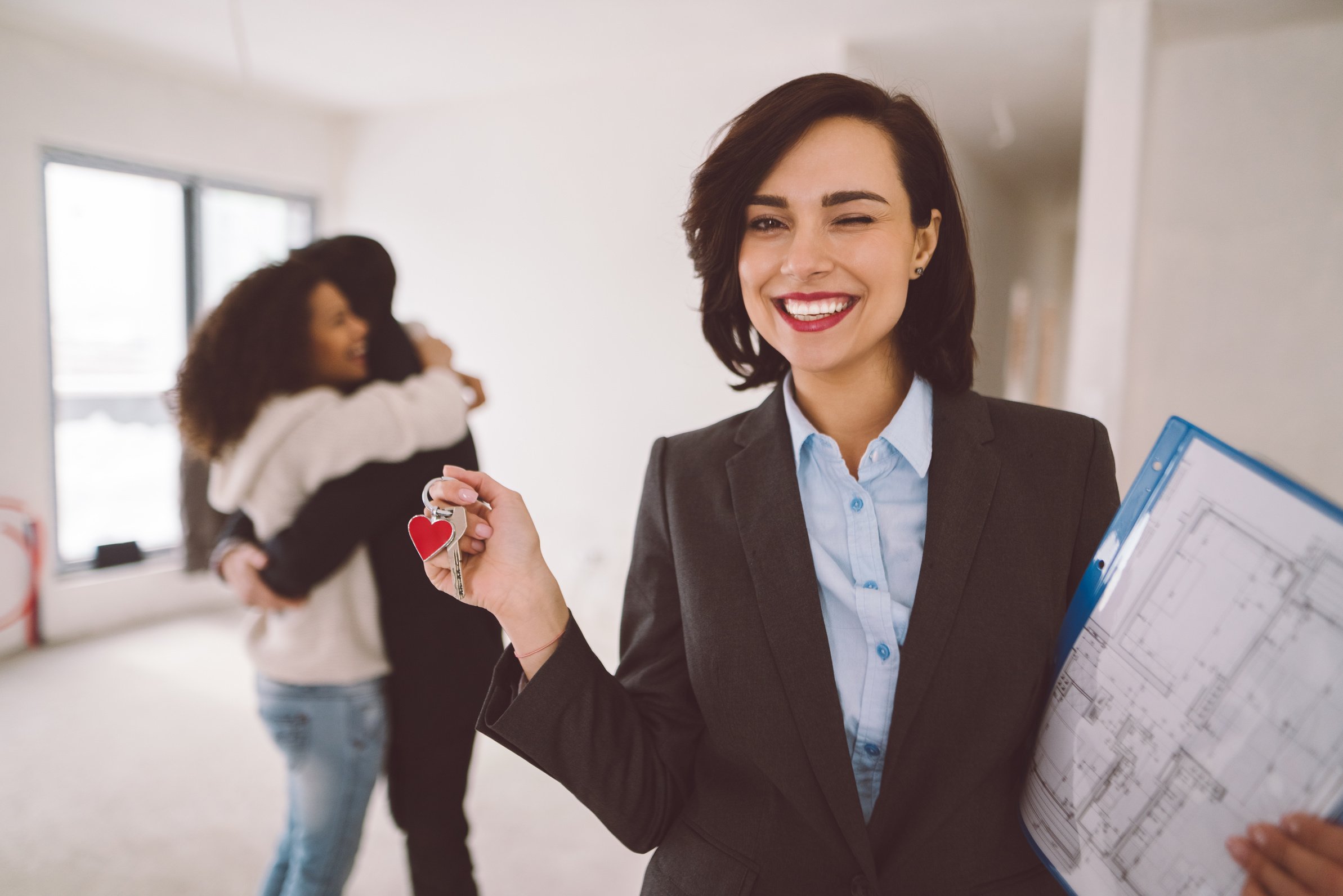 Happy real estate agent has just sold a property to young couple